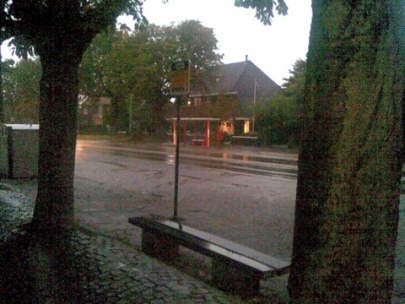 in Loenen at the busstop. in the rain. without umbrella